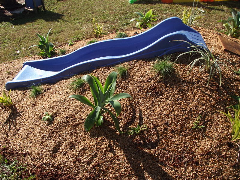 Hill Slide Fun from The Empowered Educator! Add a climbing challenge to your outdoor play area with this simple DIY mound or hill slide. No hardware required and easy to remove when no longer needed! Perfect project for parents, educators and early childhood teachers who value engaging outdoor play spaces! #outdoorplay #diy #outdoorspace #backyard #naturalplay #hillslidefun