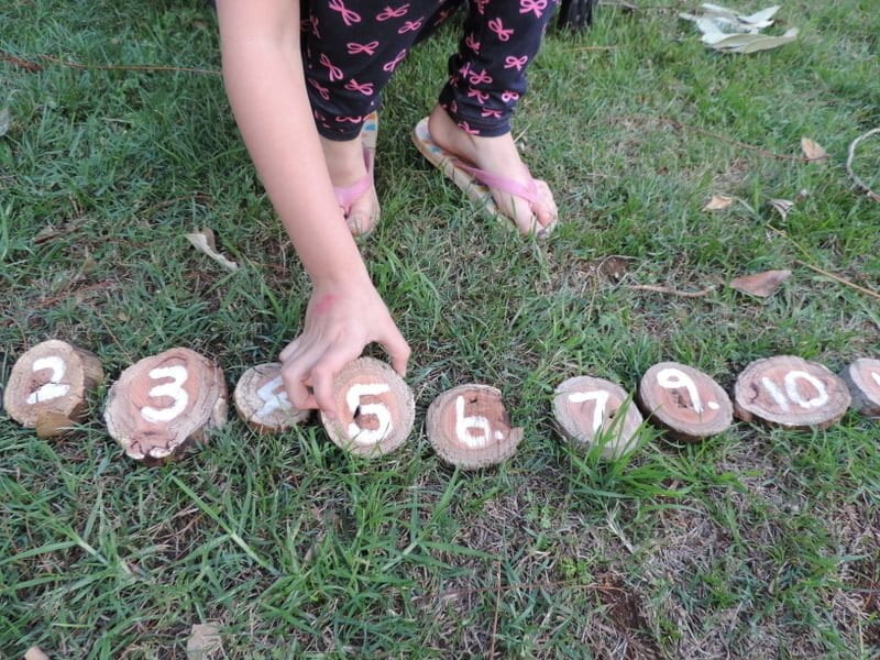 8 easy ideas to introduce play based learning activities into children's outdoor play using wooden cookies, nature and simple DIY resources. Fantastic ideas here for early childhood teachers, educators and homeschool!