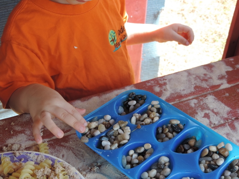 sensory play with pebbles and trays