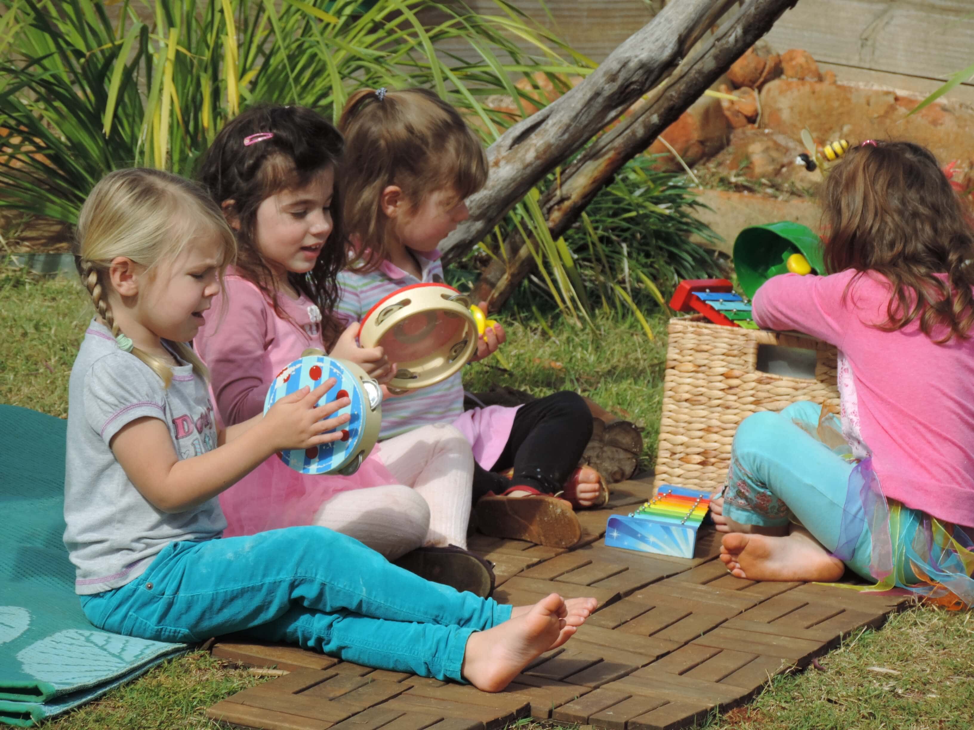group of preschool children playing musical instruments together